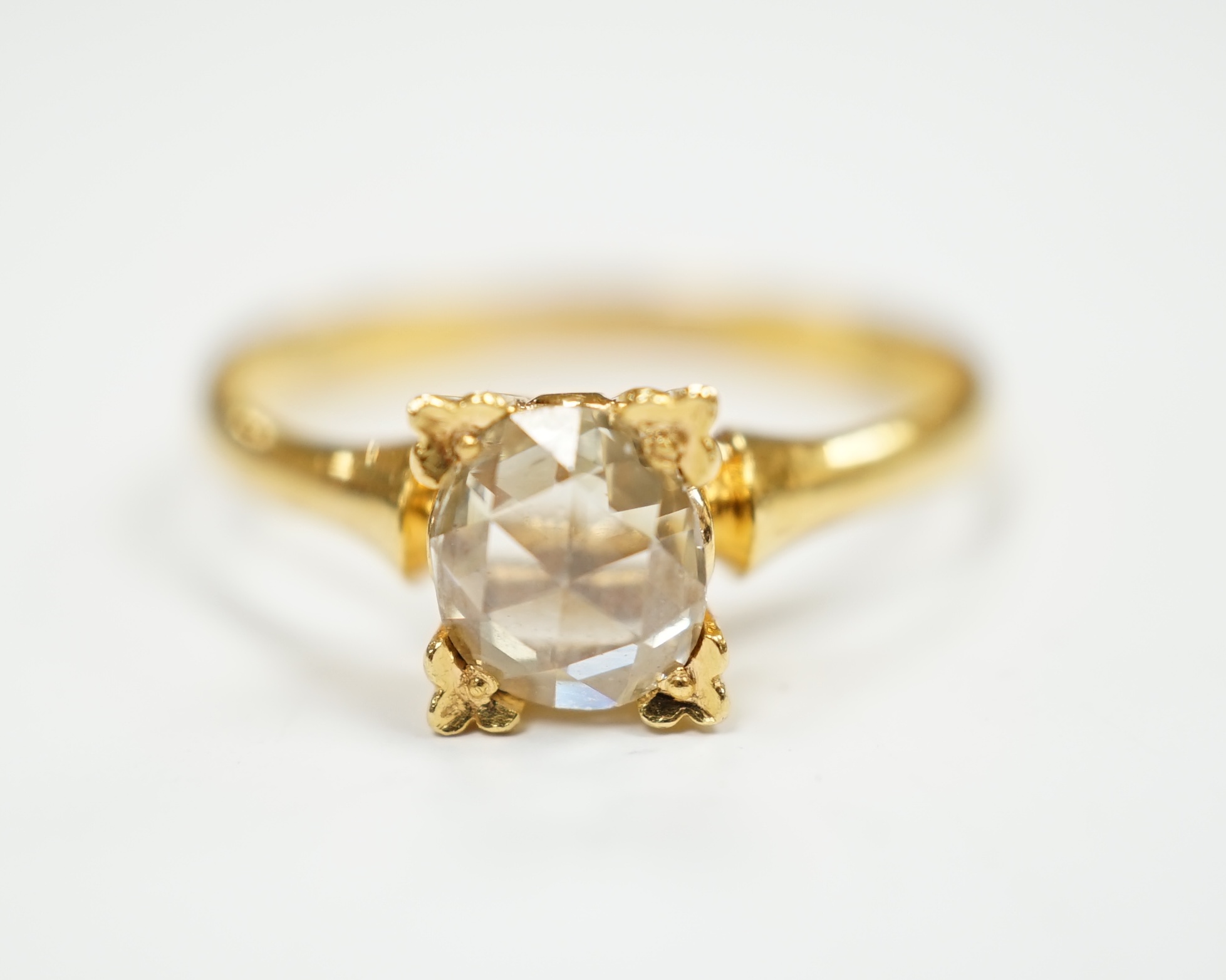 A yellow metal (stamped 22) and solitaire oval facet cut diamond set ring, size M, gross weight 2.9 grams.